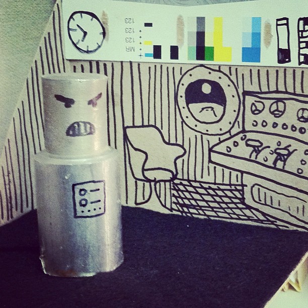 diarama of robot and control room, made from scrap steel and tissue box